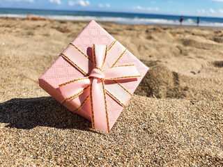 gift box on the beach. Gift box with bow and on the beach. Valentines day. Birthday 
