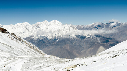 Fototapeta na wymiar Snow-capped mountains on the way down from Thorong La, Annapurna Circuit, Nepal