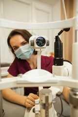 Fototapeta na wymiar Optometrist slit lamp, ophtalmology diopters calibration in oculist lab of young woman doctor.