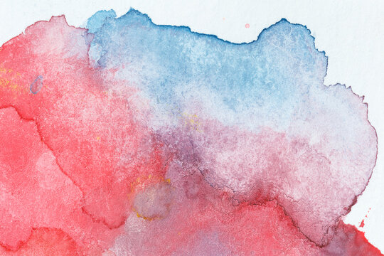 Close-up of abstract hand painted red, blue and purple watercolor background. Textured white paper background.
