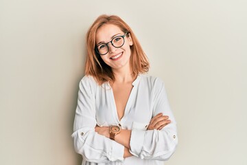 Young caucasian woman wearing casual clothes and glasses happy face smiling with crossed arms...