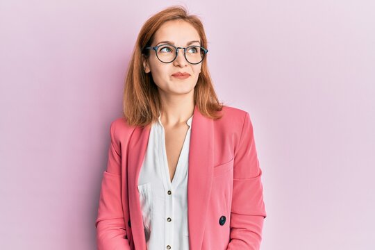 Young caucasian woman wearing business style and glasses smiling looking to the side and staring away thinking.