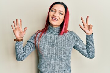 Young caucasian woman wearing casual clothes showing and pointing up with fingers number eight while smiling confident and happy.