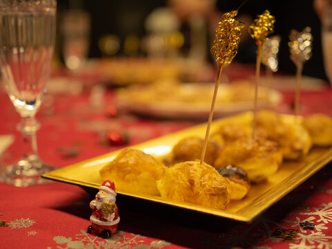 Puff pastry sausage rolls and cheese puff pastry on christmas plate with Santa Claus.