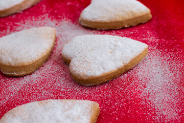Heart-shaped cookies decorated for Valentine's Day.Cookies on a red background.The concept of the Valentine's Day holiday.
