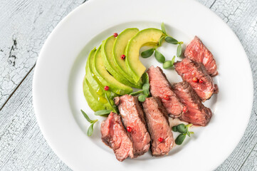 Beefsteak with sliced avocado