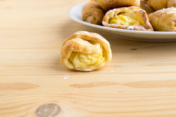 Cookies with curd filling. Delicious confectionery dessert. Cooking products are on a wooden table.