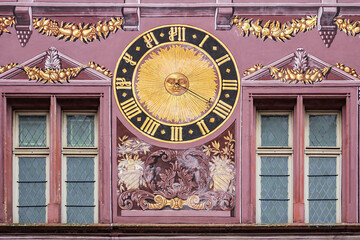 Architectural detail of old Hotel de Ville (Town Hall) on Place de la Reunion. The paintings depict...