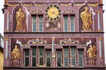 Architectural detail of old Hotel de Ville (Town Hall) on Place de la Reunion. The paintings depict...