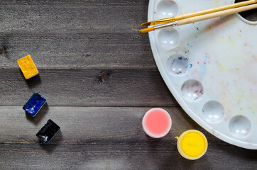 Acrylic paints on the table. Photo of art materials