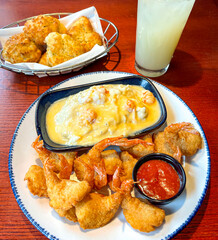 Breaded and Fried Fish with their Tales and Sides of Lobster Sauce Potatoes and Cheddar Biscuits