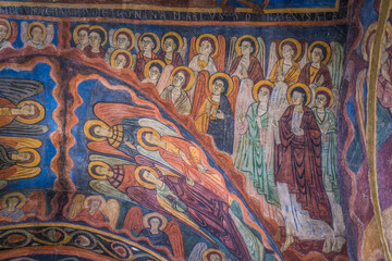 Fototapeta na wymiar Details of religious frescos inside the romanesque St Julien Basilica in Brioude, Auvergne (France)