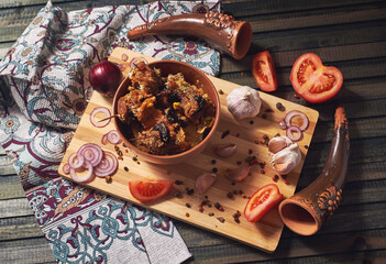 Georgian cuisine. A bowl full of spicy barbecue meat and stewed potatoes. Traditional food. Top view.