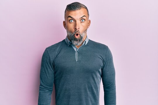 Middle age handsome man wearing casual clothes afraid and shocked with surprise expression, fear and excited face.