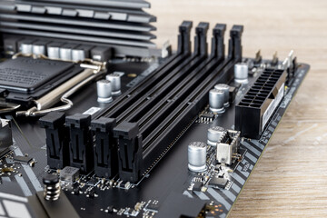 Four slots for ddr4 ram memory modules on a modern black pc motherboard. Computer mainboard circuit...