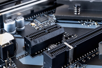PCI-E expansion slot on a modern black motherboard. Computer mainboard circuit components. Desktop...