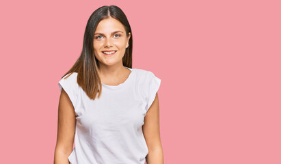 Obraz premium Young caucasian woman wearing casual white tshirt with a happy and cool smile on face. lucky person.