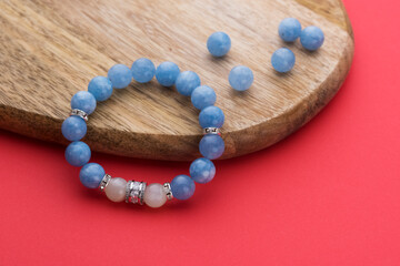 Women's bracelet from aquamarine on a wooden board with beads