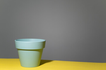 Empty flower pot in  home interior with copy space on a gray yellow background