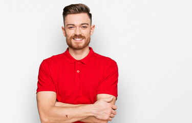 Fototapeta premium Young redhead man wearing casual clothes happy face smiling with crossed arms looking at the camera. positive person.
