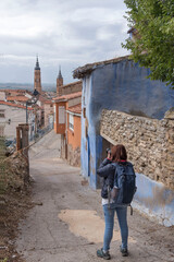 Vertical shot of a woman taking photos in Calatayud, Aragon, Spain