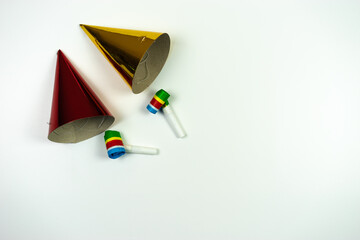 New year composition. Party hats with whistles on white background. Flat lay, top view.