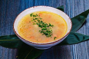 Fish soup with salmon, sea bass, vegetables in a bowl.