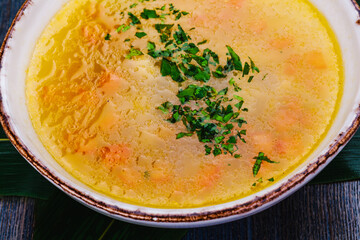 Fish soup with salmon, sea bass, vegetables in a bowl.