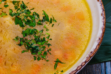 Fish soup with salmon, sea bass, vegetables in a bowl.