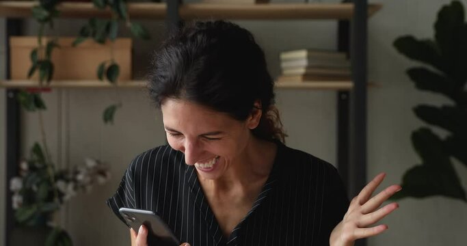 Woman hold smartphone check email read sms with great news feels happy celebrate success dancing looking very happy crazy and funny. Lottery win, career advance, salary growth, date invitation concept