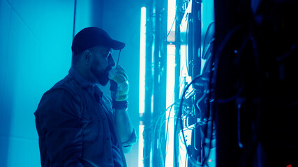 Fototapeta na wymiar Bearded man repairing LED monitor in smoke