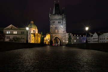 cobblestones and street lights on Charles Bridge at night in the Czech Republic