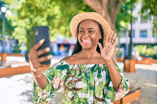 Young african american tourist woman on vacation smiling happy doing video call using smartphone at the city.