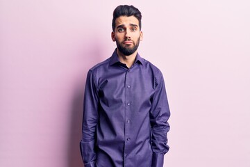 Young handsome man with beard wearing casual shirt depressed and worry for distress, crying angry and afraid. sad expression.