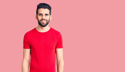 Young handsome man with beard wearing casual t-shirt with a happy and cool smile on face. lucky person.