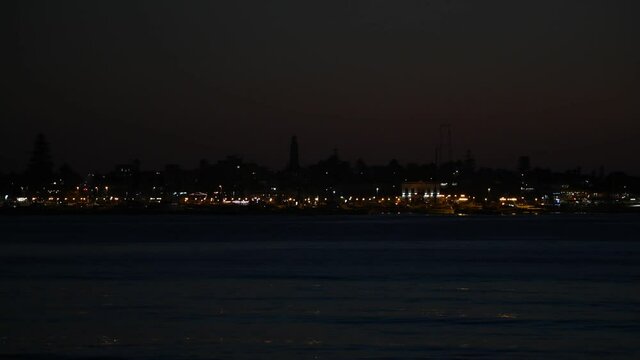 View of Punta del Este lights at dusk, seen from Mansa Beach in Punta del Este lighthouse can be seen in the middle of the frame.