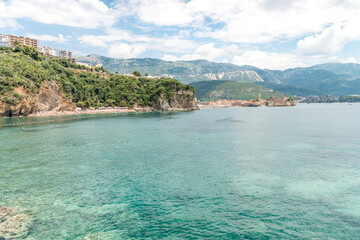 Naklejka premium Calm sea with beach and Budva old town on a sea shore