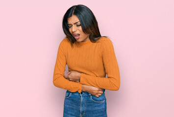 Young latin transsexual transgender woman wearing casual clothes with hand on stomach because nausea, painful disease feeling unwell. ache concept.