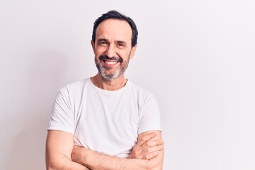 Middle age handsome man wearing casual t-shirt standing over isolated white background happy face smiling with crossed arms looking at the camera. Positive person.