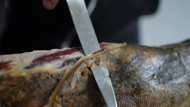 Slicing jamon serrano ham, traditional spanish meat culture