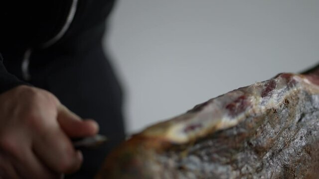 Slicing jamon serrano ham, traditional spanish meat culture