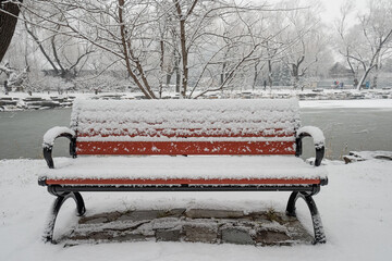 A snow-covered bench