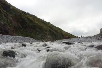 Heddon river flowing through the valley and over rocky ground