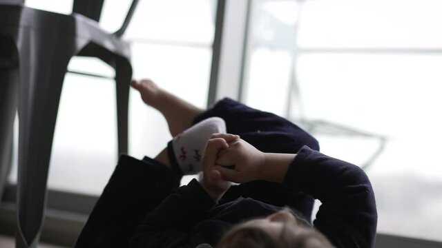 Toddler removing socks from feet clothing