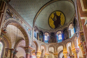Fototapeta na wymiar the colorful frescoes covering the walls and ceiling of the choir of the romanesque Saint Austremoine abbey church in Issoire, Auvergne (France) 