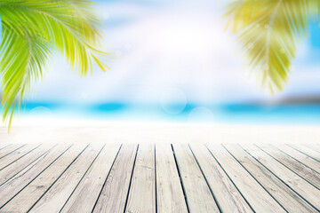 Empty wooden table, white sand on the beach and summer sky for editing or showing your products.