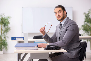 Young male employee working in the office
