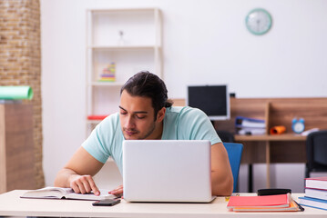 Young male student preparing for exams at home in tele-education