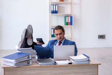 Young male bookkeeper calculating expences