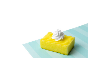 Yellow sponge for dishwashing with foam on blue and white background